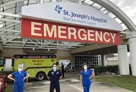 A team of healthcare workers greets visitors to the emergency room at St. Joseph's Hospital in Tampa.