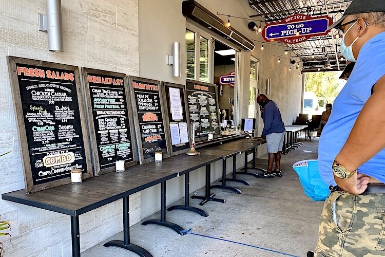 Customers line up for takeout food at La Segunda Bakery & Cafe in West Tampa.