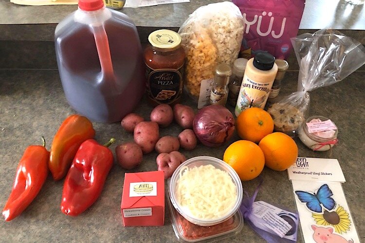 SaucyQueen farmer's market products unboxed after being dropped off.