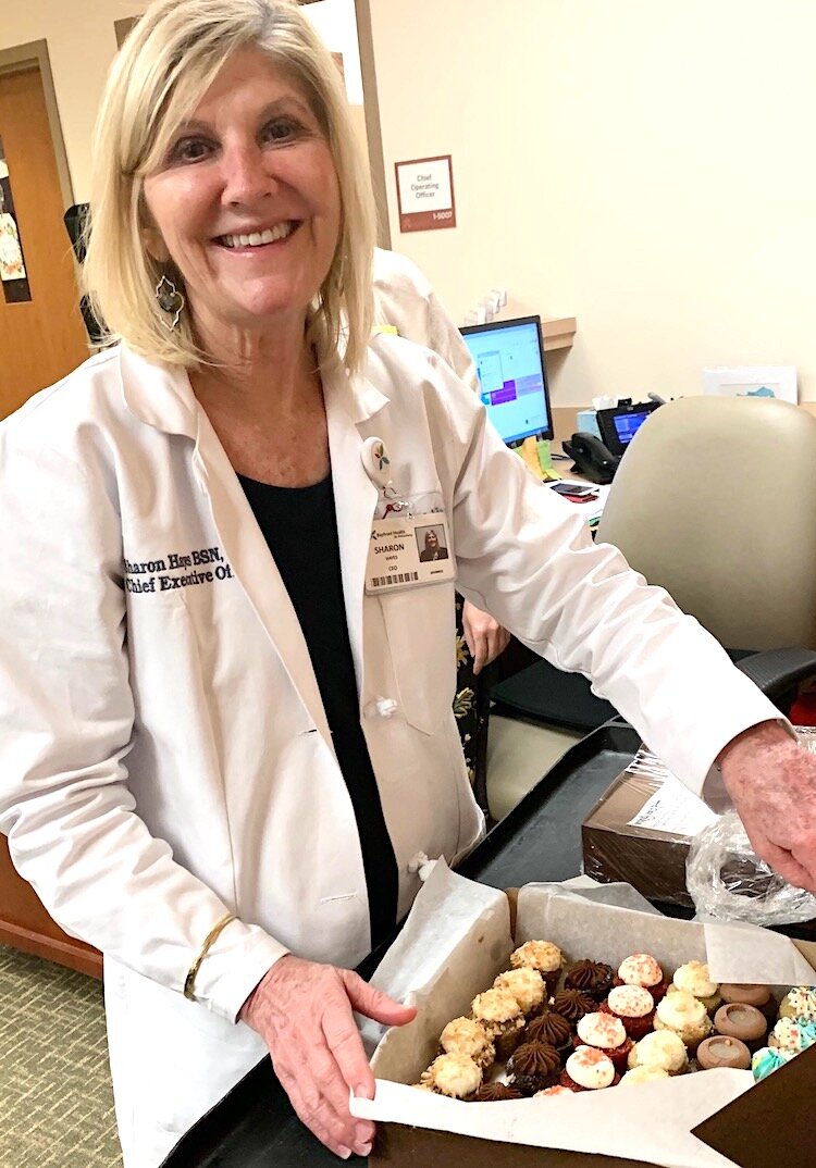Sharon Hayes, CEO of Bayfront Medical Center in St. Pete, preparing to share minis from (swah-rey) with her colleagues.