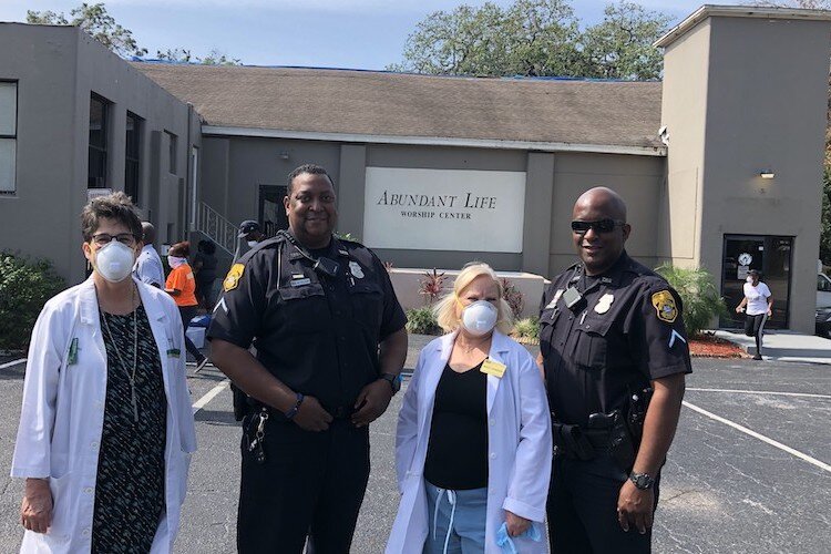 Denise Maguire, Marcus Elam, Marcia Johansson, and Ryan O'Neil distribute resources and assess family needs at an outreach event for the Sulphur Springs community at Abundant Life Church.