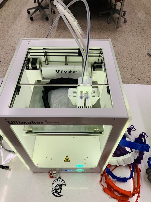 A 3D printer at the University of Tampa Fab Lab prints the headbands used to keep the protective shield in place.