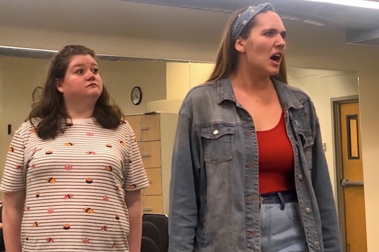 Bélise (Alexa Sheppard, left) watches as Philaminte (Faith Kopecky, right) spits fire at her husband, Chrysale (not pictured).