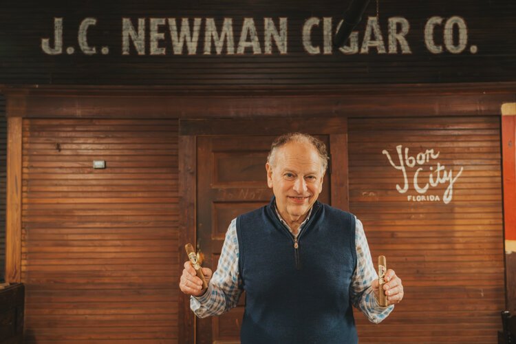 J.C. Newman President and co-owner Eric Newman holds two cigars hand-rolled at the El Reloj  factory in Ybor City. "There is nothing else made today that's still made the same way it was made in 1895," Newman says.