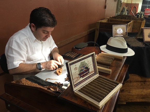 A cigar roller at J.C. Newman Cigar Company puts finishing touches on cigars.
