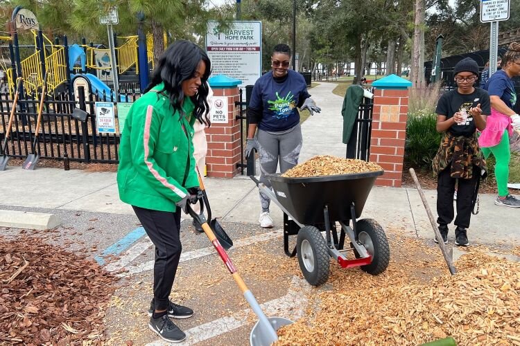 Community volunteers do some landscaping at Harvest Hope Park during the University Area CDC's annual "Paint the Town" service event for Martin Luther King Jr. Day.