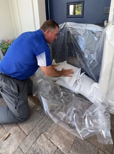 Greg Brown, with Hillsborough County Parks & Recreation, demonstrates how to set sandbags to protect your home from rising water.