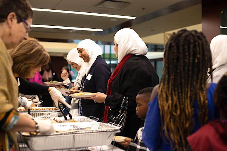 People of the Jewish, Muslim, and Christian faiths share a Thanksgiving meal in welcoming recent refugees to Tampa.