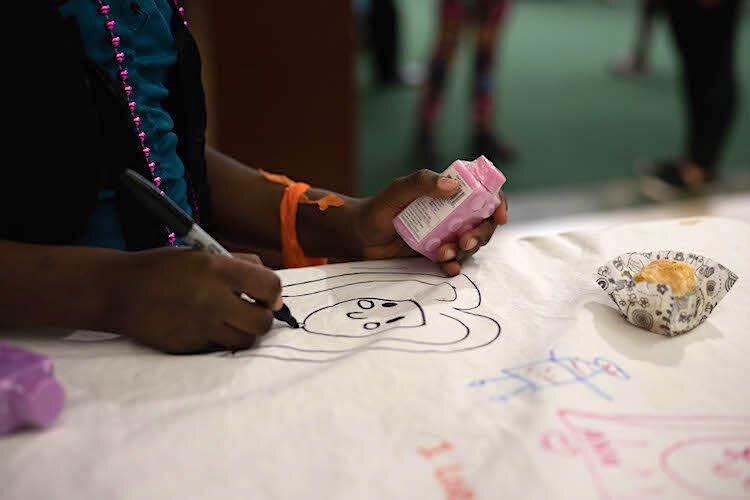 Fun activities designed to encourage cross-cultural conversations and friendships are part of the Refugee Interfaith Thanksgiving held at the Gibbons Alumni Center at USF.