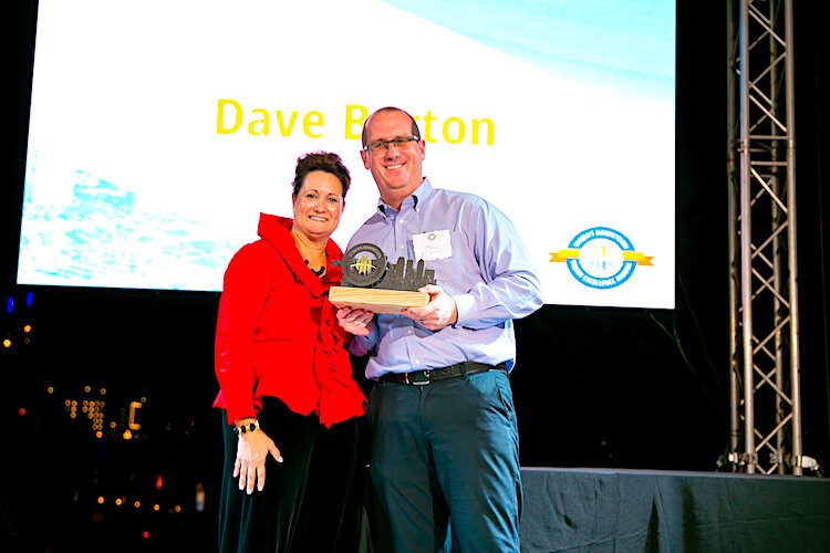 Tampa Downtown Partnership President and CEO Lynda Remund presents Person of the Year Award to businessman Dave Burton.