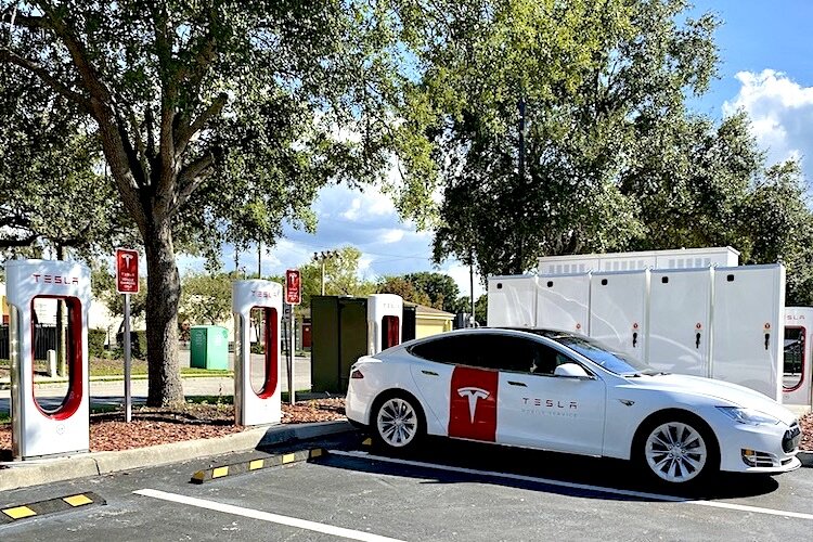 A dealer's Tesla backs up to a charging station at Winn Dixie on Swann Avenue in South Tampa.