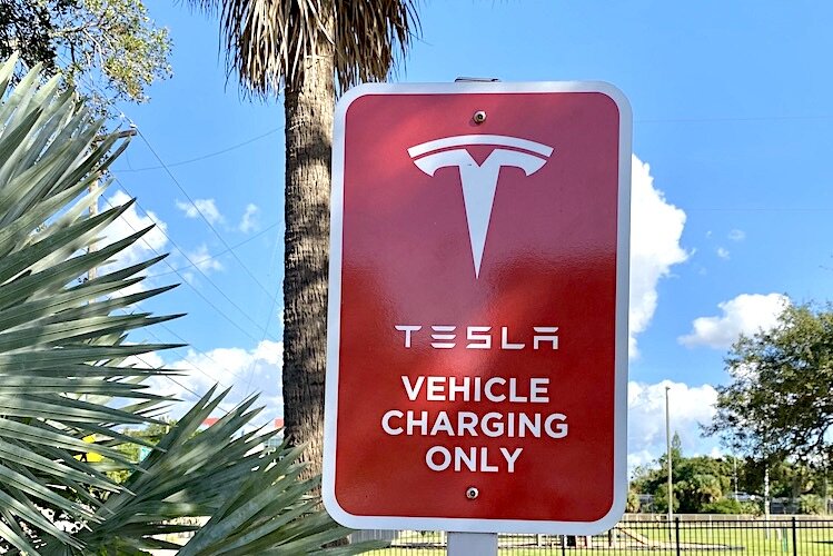 Parking spaces are reserved for charging electric vehicles.