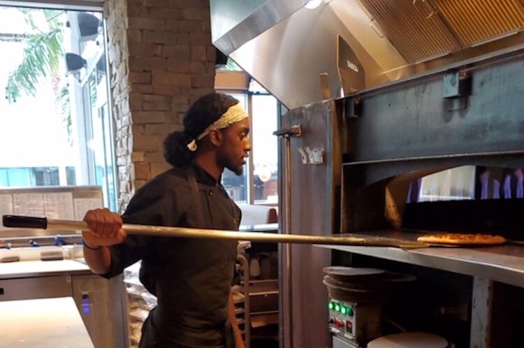 Scholarship winner Lavante Pope putting his skills to work at Oak and Stone in St. Petersburg.