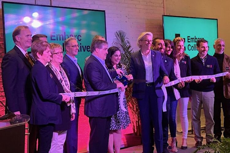 Tampa Bay dignitaries line up to cut the ribbon on Embarc Collective. CEO Lakshmi Shenoy stands between investor Jeff Vinik and Mayor Jane Castor.