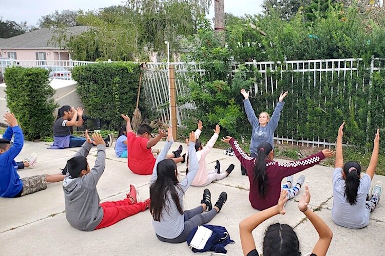 Breathe and stretch: a yoga class at Wholesome Winter Kids Camp provides youngsters with a healthy tool to manage stress.