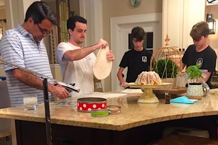 The Koop family making mini fried pizzas.