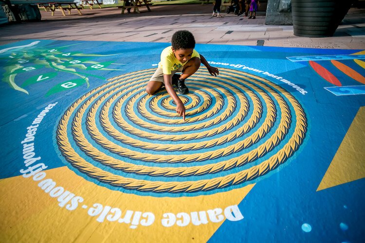 A big tent at Curtis Hixon Park offers a shady spot for family-friendly outdoor fun.