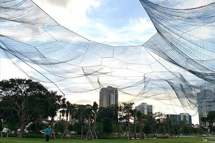 Bending Arc by Janet Echelman in daylight.