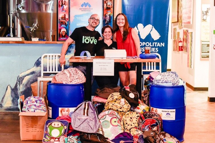 Backpack to School Founder Raubi Perilli with some of the backpacks donated in 2019.