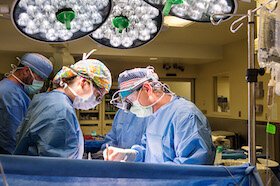 Cardiovascular surgeon replacing a valve during heart surgery at Tampa General Hospital.