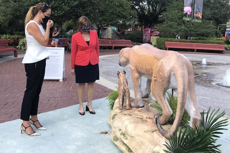 CLEO Institute Executive Director Yoca Ardita-Rocha and Rep. Kathy Castor observe a melting wax sculpture at ZooTampa as they kick off the #FLClimateCrisis campaign.