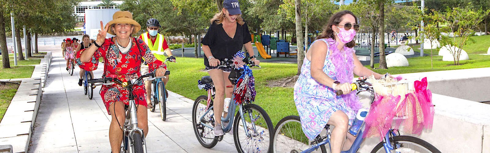 Cyclist Janet Scherberger flashes a peace sign on the first leg of Sunday's six-mile "Fancy Women Bike Ride" to promote bicycle safety and camaraderie among female cyclists.