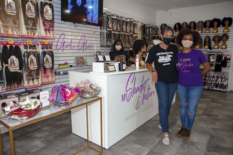 Entrepreneur Candy Lowe, Founder of the nonprofit Black Business Bus Tour, now introduces customers to Pam Thompson of "My Shades & Texture" beauty supply on Busch Boulevard in Tampa during Buy Black Saturday.