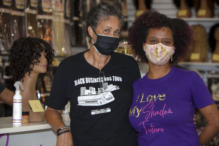 Entrepreneur Candy Lowe of the Black Business Bus Tour visits Pam Thompson of "My Shades & Texture" beauty supply on Busch Boulevard on Buy Black Saturday.