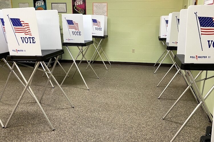 Voting booths have been spaced out to better ensure safety during COVID-19. Masks are required.