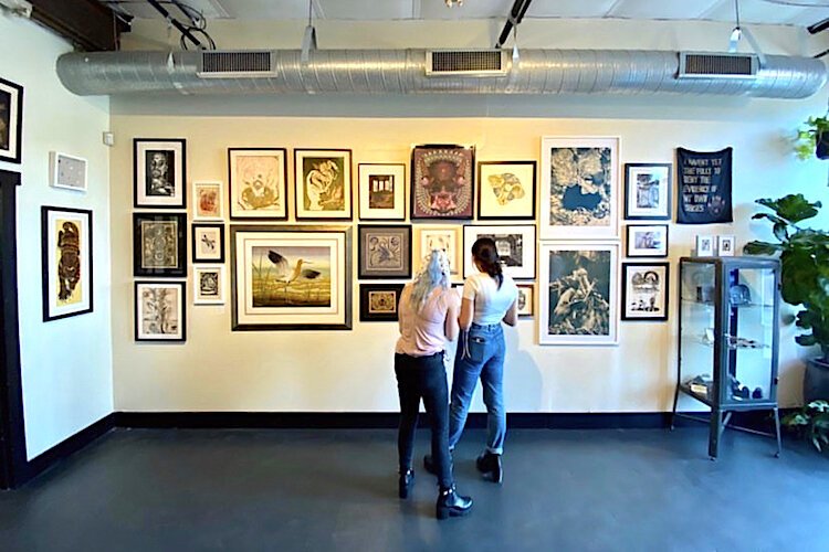 Visitors take a look at the art on display at the new Labyrinth gallery, studio, and makerspace in Seminole Heights.