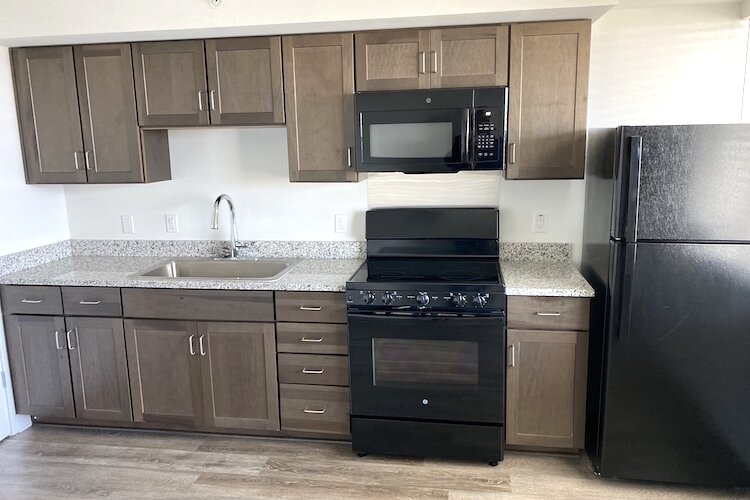 Brand new kitchens with granite countertops and modern appliances await senior tenants.