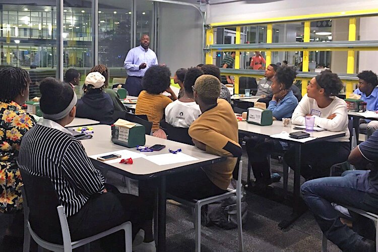 Students listen to co-founder Ed Narain during the BLN Monthly Scholars Meeting. The themed monthly gatherings are facilitated by BLN Scholars and feature guest speakers from the community.