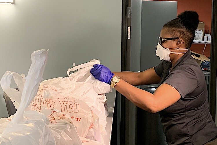 Tampa Housing Authority staff distributes donated meals and food to residents during the pandemic.