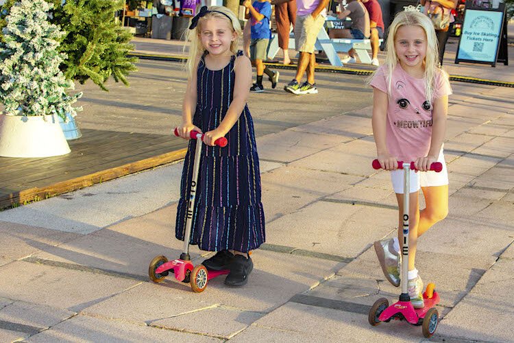 Twins Sofia and Chloe, age 5, enjoy Curtis Hixon’s Winter Village along with their mom, Beth Ricard.