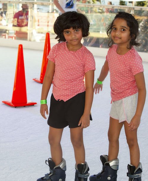 Twins Anshika and Tanishka Kiran, age 7, join their mom, Premalatha Singh, for an afternoon of ice skating at the Winter Village.