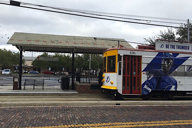 A streetcar pulls into a passenger pickup stop in Ybor City.