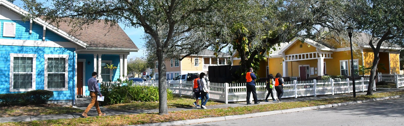 The walking tour moves past colorful houses that brighten the streets of the College Hill/Belmont Heights neighborhood.
