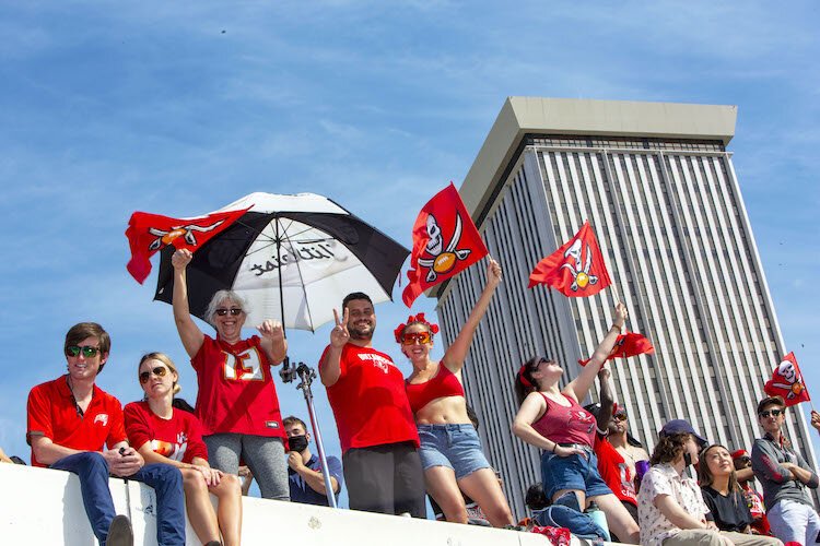 Buccaneer fans await boats loaded with the Super Bowl LV Champion Tampa Bay Buccaneers in Curtis Hixon Park on the Hillsborough River in downtown Tampa.