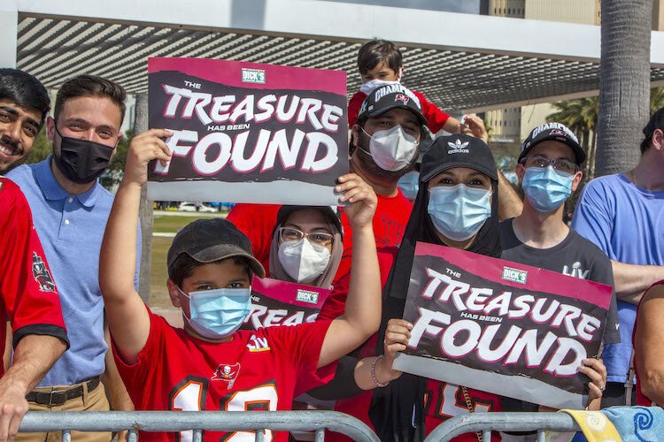 Clutching their "The Treasure Has Been Found" signs, Tampa native Farah Khan, right, and her 9-year old son, Zayd, declared "There is no other team for us!"