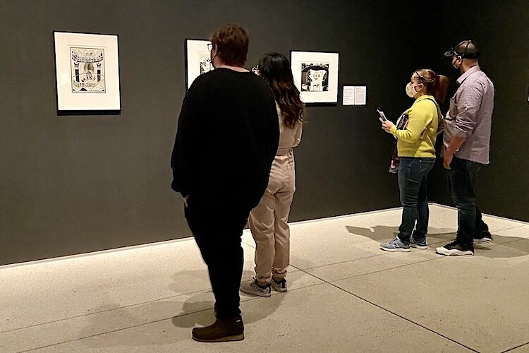 Friends and families keep their social distance while taking in a variety of exhibits.