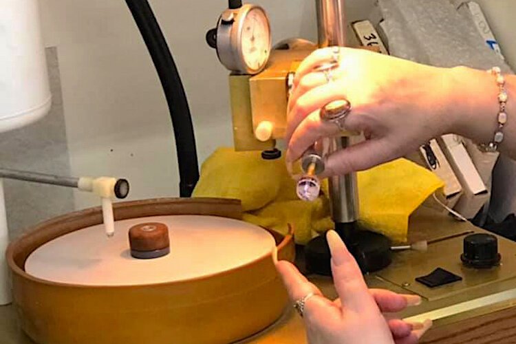 A faceting student working on the pavilion of their faceted stone