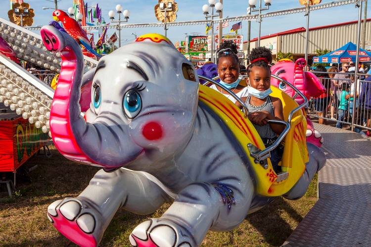 Lots of kiddie rides at the Strawberry Festival keep moms and dads at least as happy as their offspring.