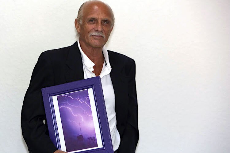 Former Tampa Tribune Photographer Fred Bellet holds his most iconic, sought-after photo: "Purple Rain," taken in 1992.