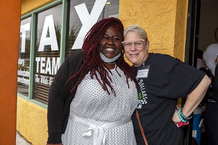 Brandye Wilds, proprietor of "Tax Team Wilds Sisters," greets longtime Black Business Bus Tour supporter Beth Shoup at her business on Dr. Martin Luther King Boulevard.