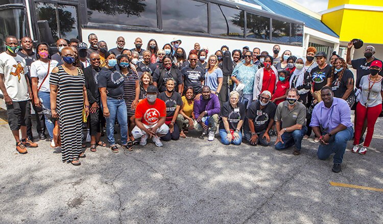 Many of the attendees of Saturday's Black Business Bus Tour gathered outside "Hip Hop Crab" and "Cocoa's Fashion," adjacent stops on Candy Lowe's tour of African-American owned businesses.