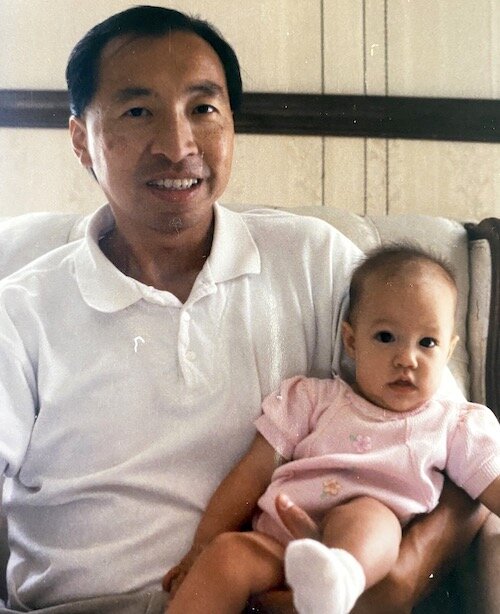 Lauren Wong's father holding her as a toddler.
