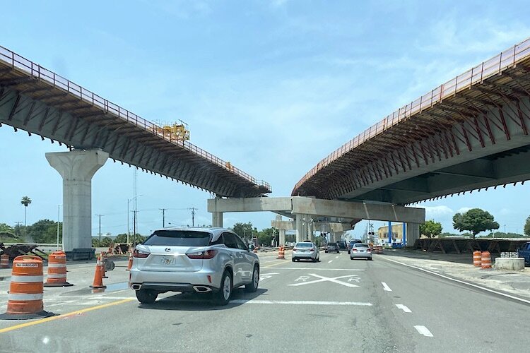 The elevated expressway cuts the travel time between Tampa and St. Petersburg while local traffic can stop at businesses on the ground.