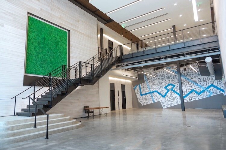 Bosco Sodi’s painting All the Mornings of the World can be seen alongside Ya La’Ford’s mural Waterfrontier in the Strategic Property Partner’s lobby at Sparkman Wharf.