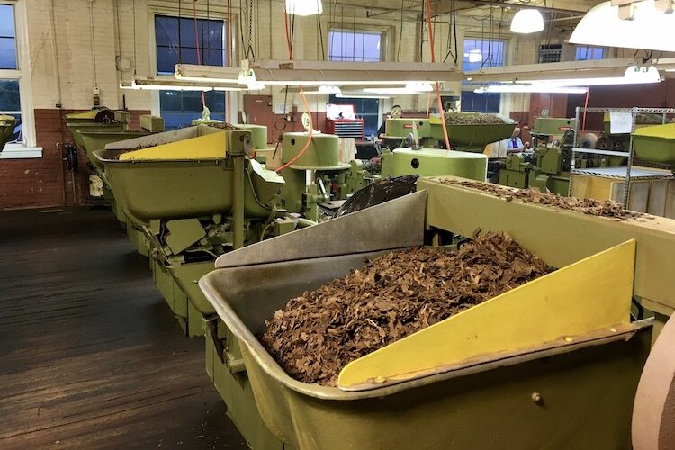 Bins of tobacco await processing into premium cigars.