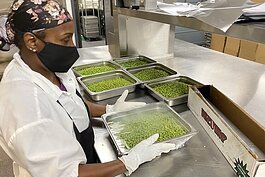 Tonia Hutchins readies fresh veggies for heating in industrial size steamers.